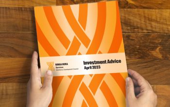 A close-up of two hands holding a booklet titled 