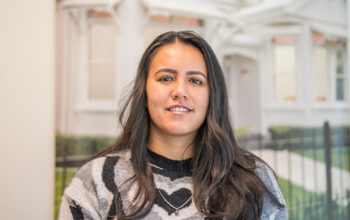A close up of a person wearing a black and white top.