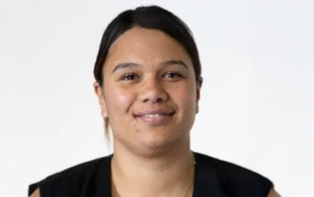 A women smiling towards the camera.